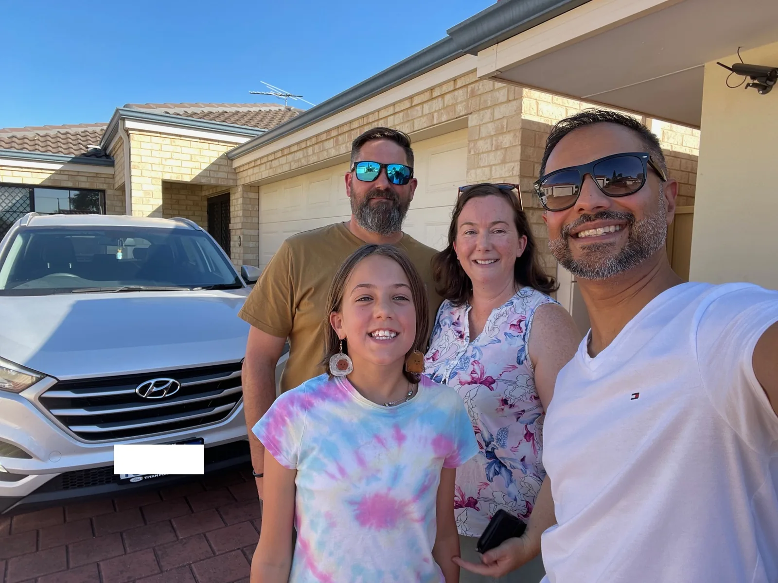 A family with Jay Gami after securing their home