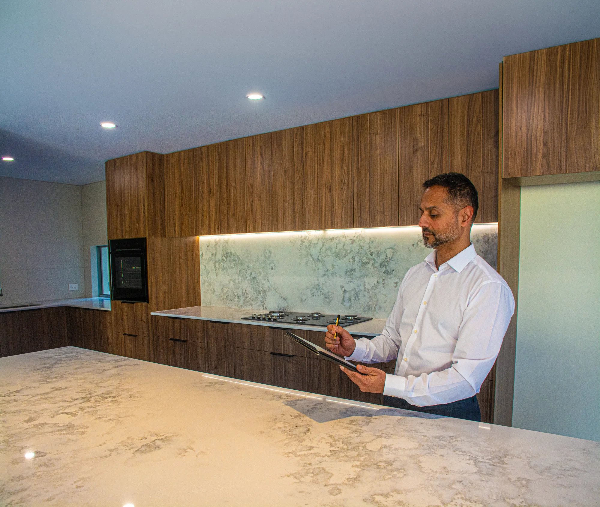 Buyer’s agent reviewing a property inspection in a modern kitchen