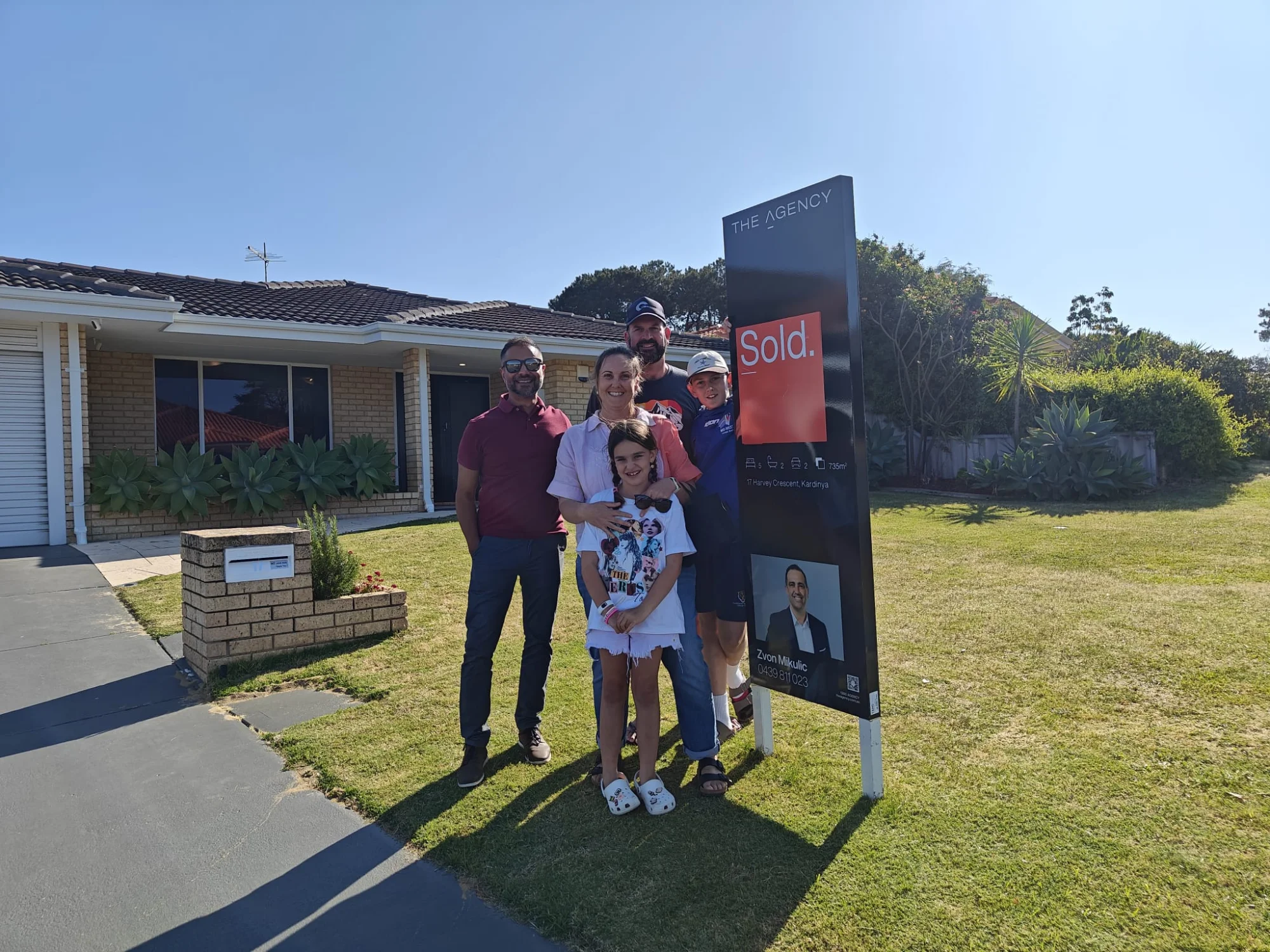 Jay Gami with clients outside their newly purchased home